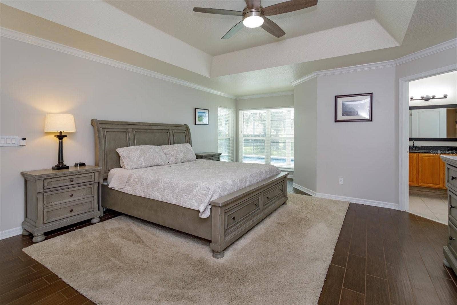 6887 HIDDEN GLADE PLACE, Sanford, FL 32771 Freshly painted primary bedroom with sitting area and wood look tile