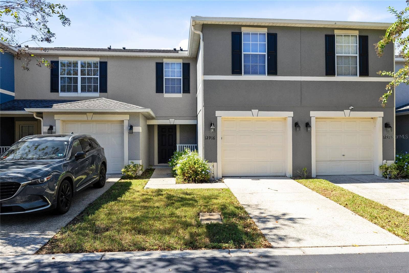 12916 LEXINGTON SUMMIT STREET, Orlando, FL 32828 Front entrance with garage