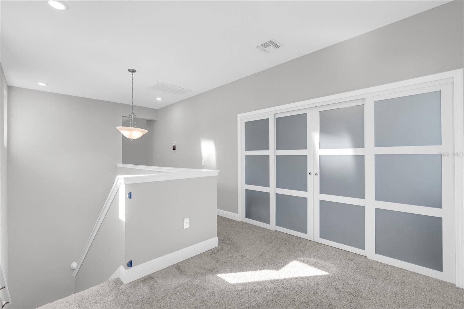 14026 FRASIER STREET, Winter Garden, FL 34787 Sliding doors connecting the loft and upstairs landing