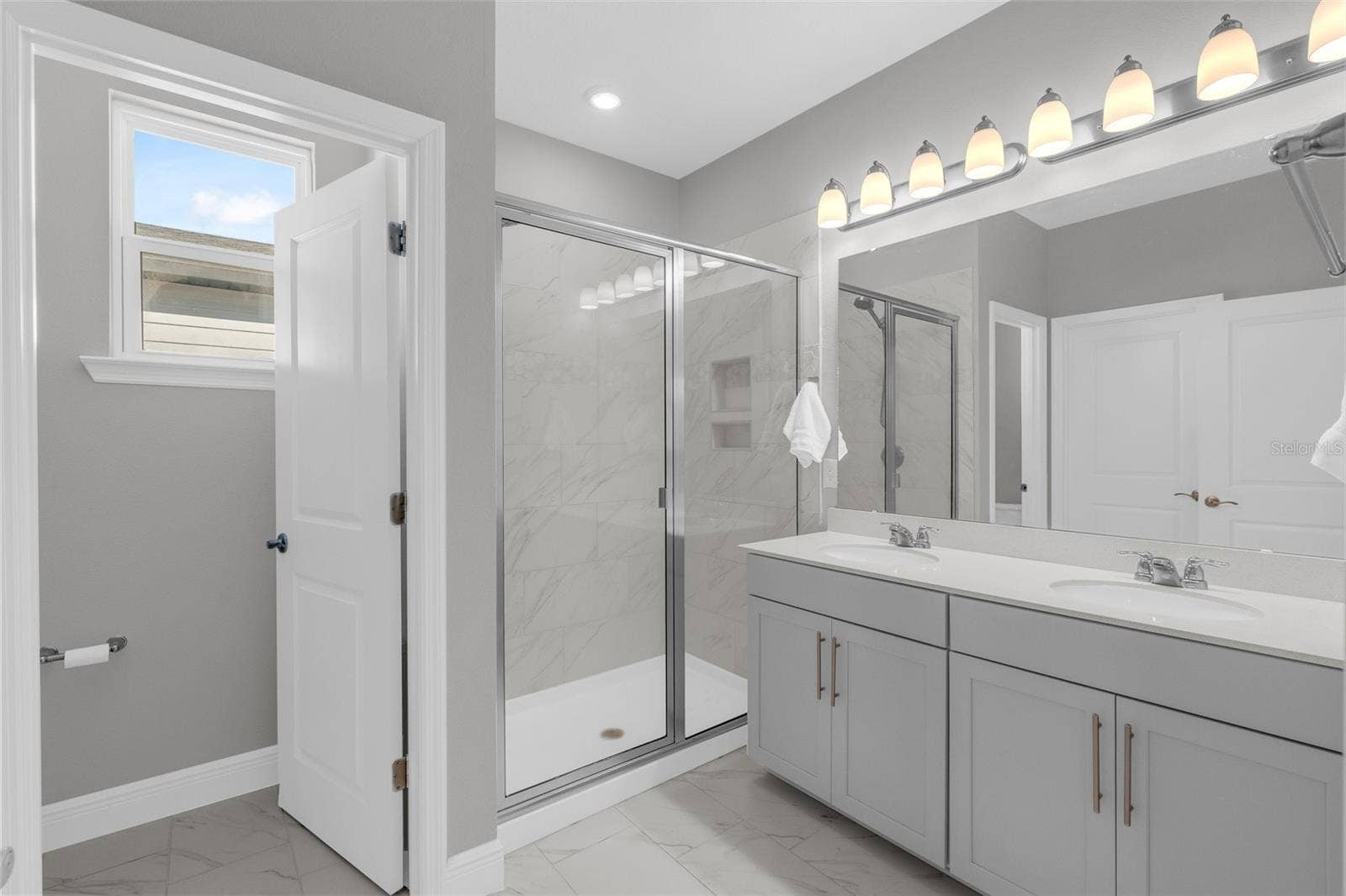 14026 FRASIER STREET, Winter Garden, FL 34787 Primary bathroom with dual-sink vanity and glass-enclosed shower