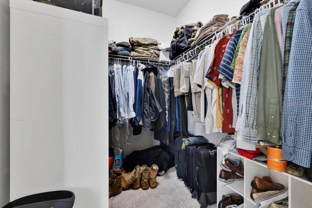 Primary bedroom walk-in closet 1 of 2