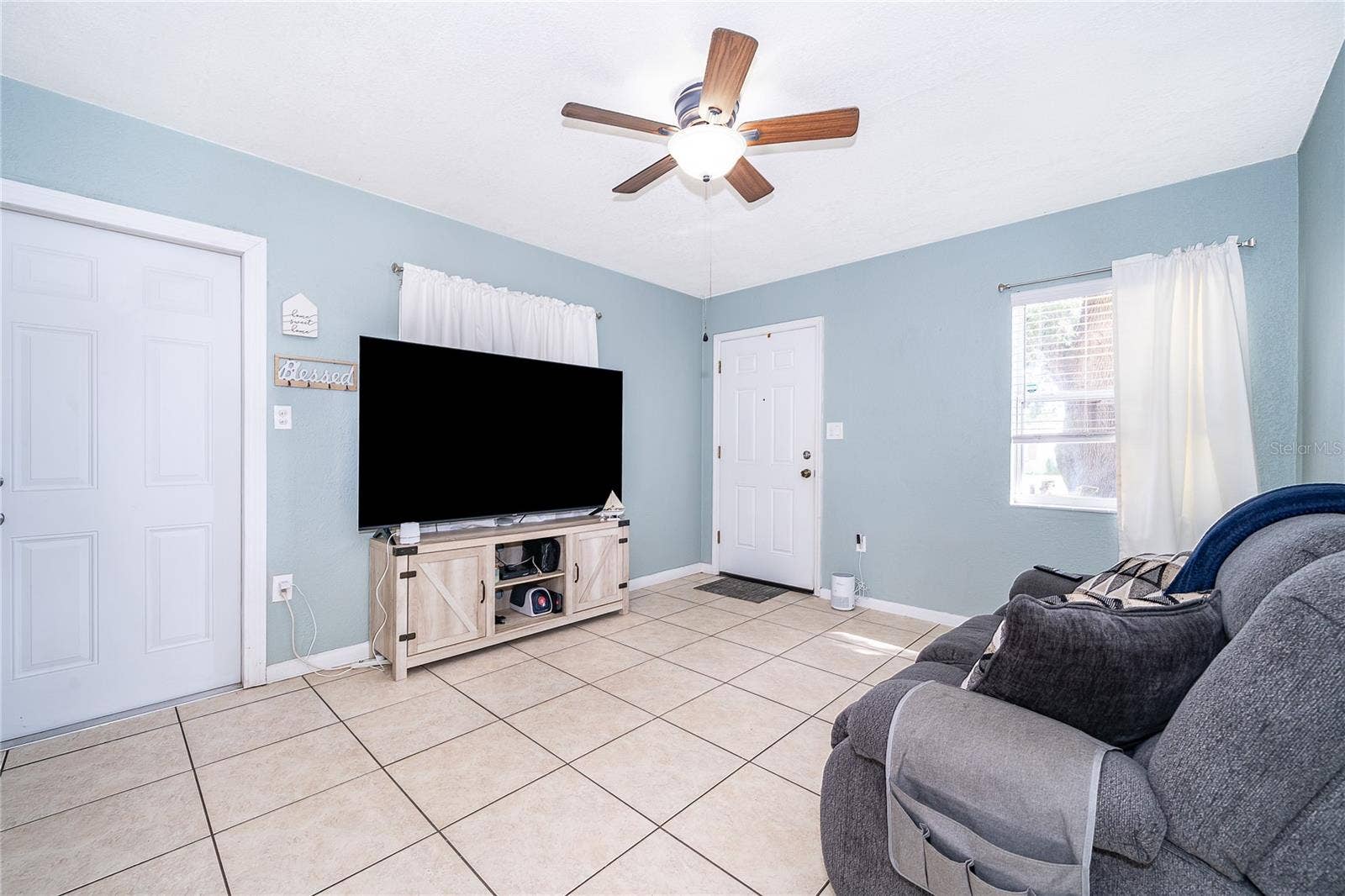 800 DORADO AVENUE, Orlando, FL 32807 Make yourself at home in this comfortable living room, offering natural light and plenty of space to gather with family and friends.