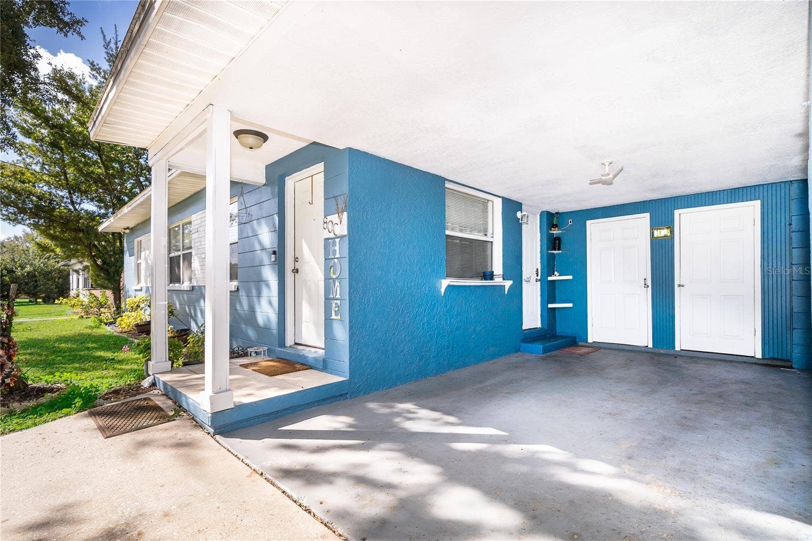800 DORADO AVENUE, Orlando, FL 32807 Enjoy the convenience of an attached garage, a spacious driveway, and a welcoming front entrance.
