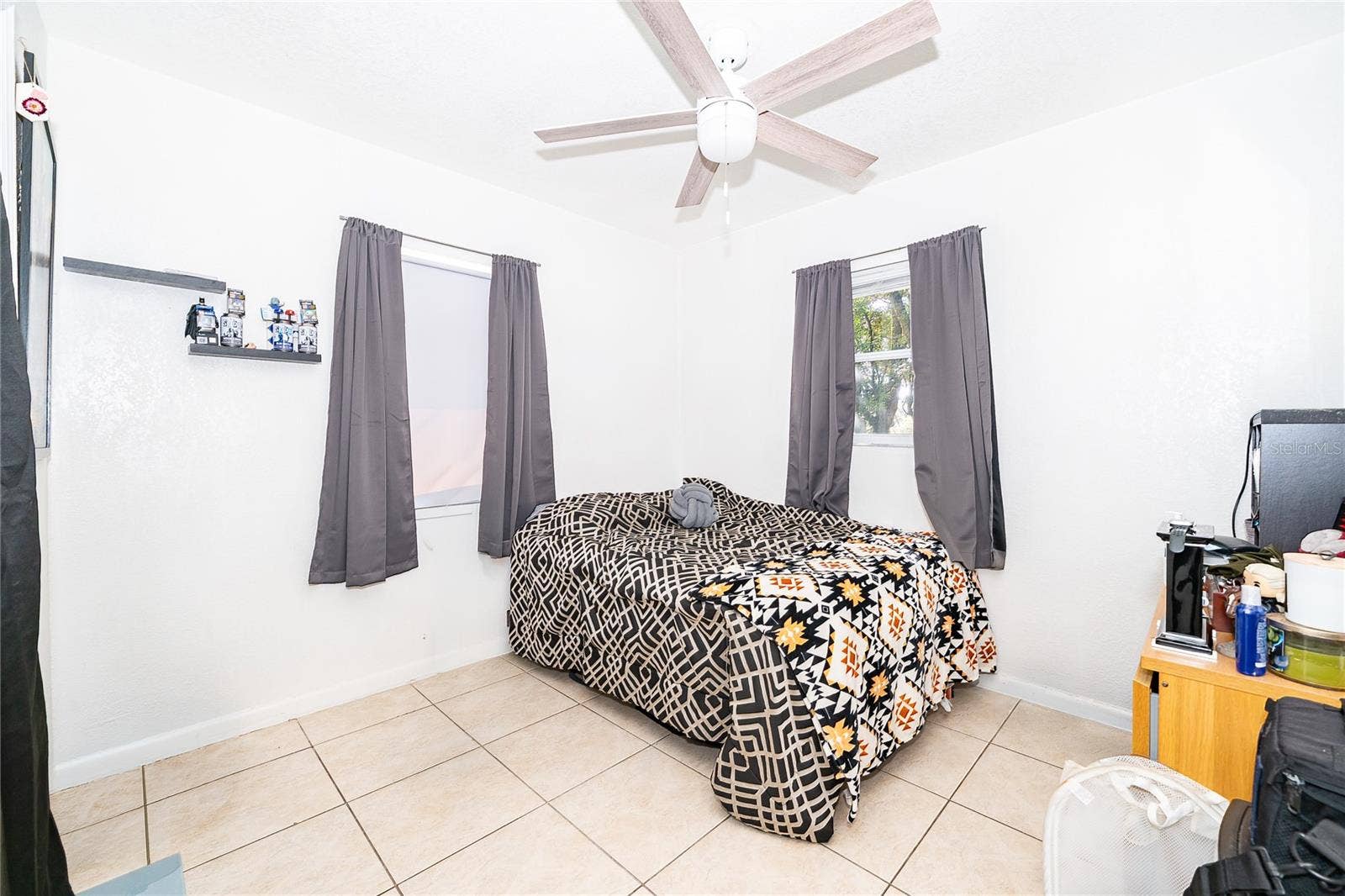 800 DORADO AVENUE, Orlando, FL 32807 A comfortable bedroom filled with natural light, offering a relaxing space to unwind and recharge.