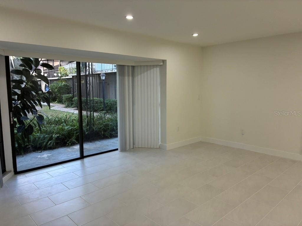 5999 VILLAGE CIRCLE, #990, Orlando, FL 32822 Living room and view of rear porch
