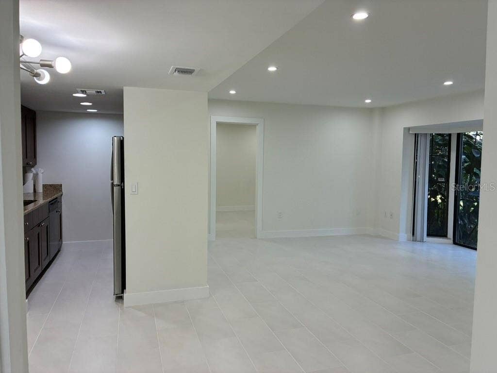 5999 VILLAGE CIRCLE, #990, Orlando, FL 32822 Living room and Kitchen from front door