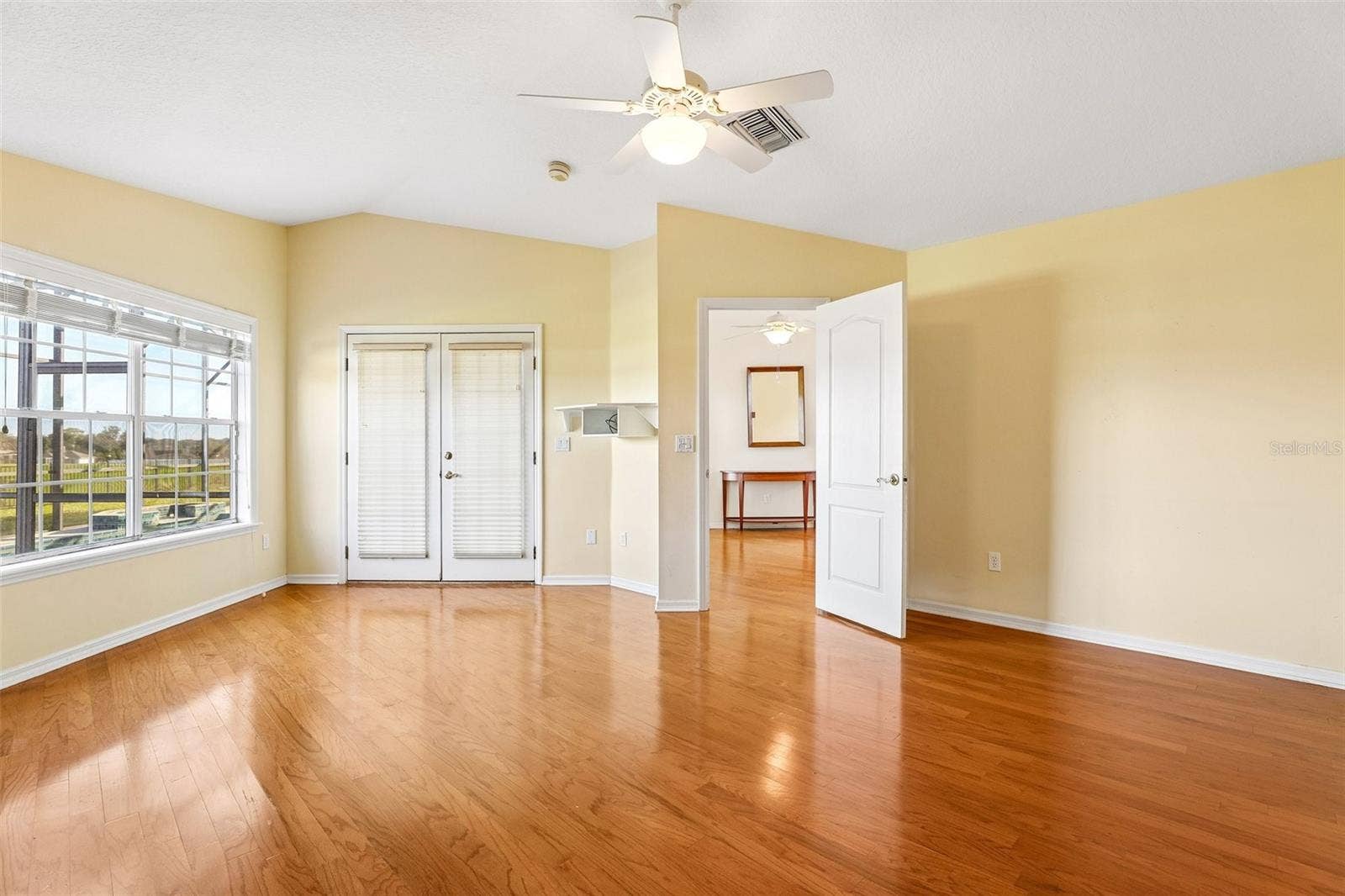7891 BRIDGESTONE DRIVE, Orlando, FL 32835 Master Bedroom leading back to Living Room