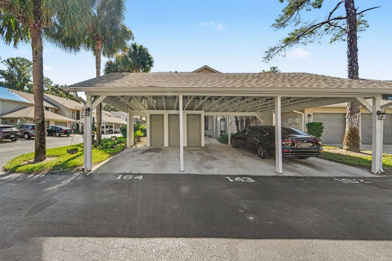 143 CROWN POINT CIRCLE, #143, Longwood, FL 32779 Covered Carport with Multiple Parking Spaces and Tropical Landscaping