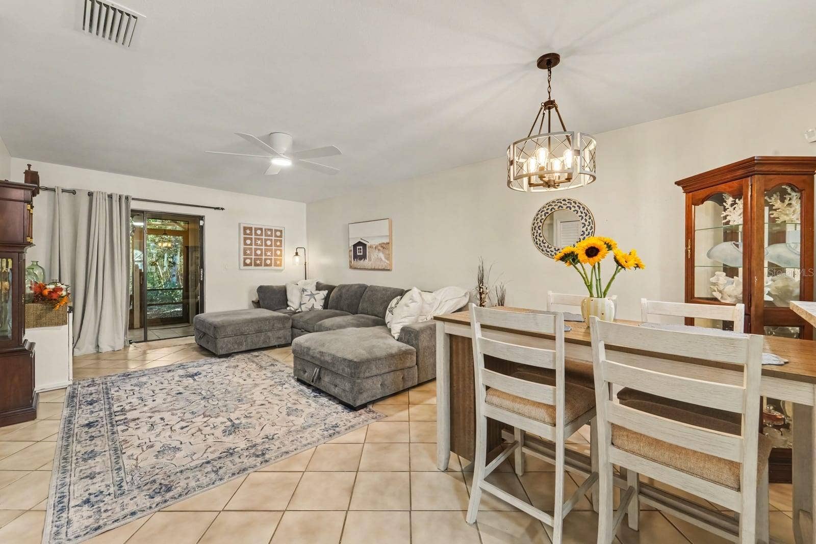 143 CROWN POINT CIRCLE, #143, Longwood, FL 32779 Dining and Living Spaces Flow Together with Pendant Lighting and Display Cabinet