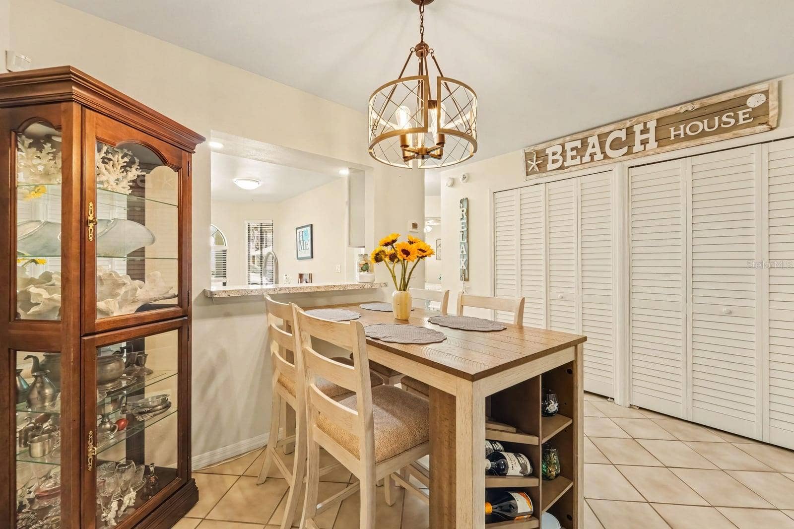143 CROWN POINT CIRCLE, #143, Longwood, FL 32779 Elegant Dining Area with Island Storage and Pendant Lighting