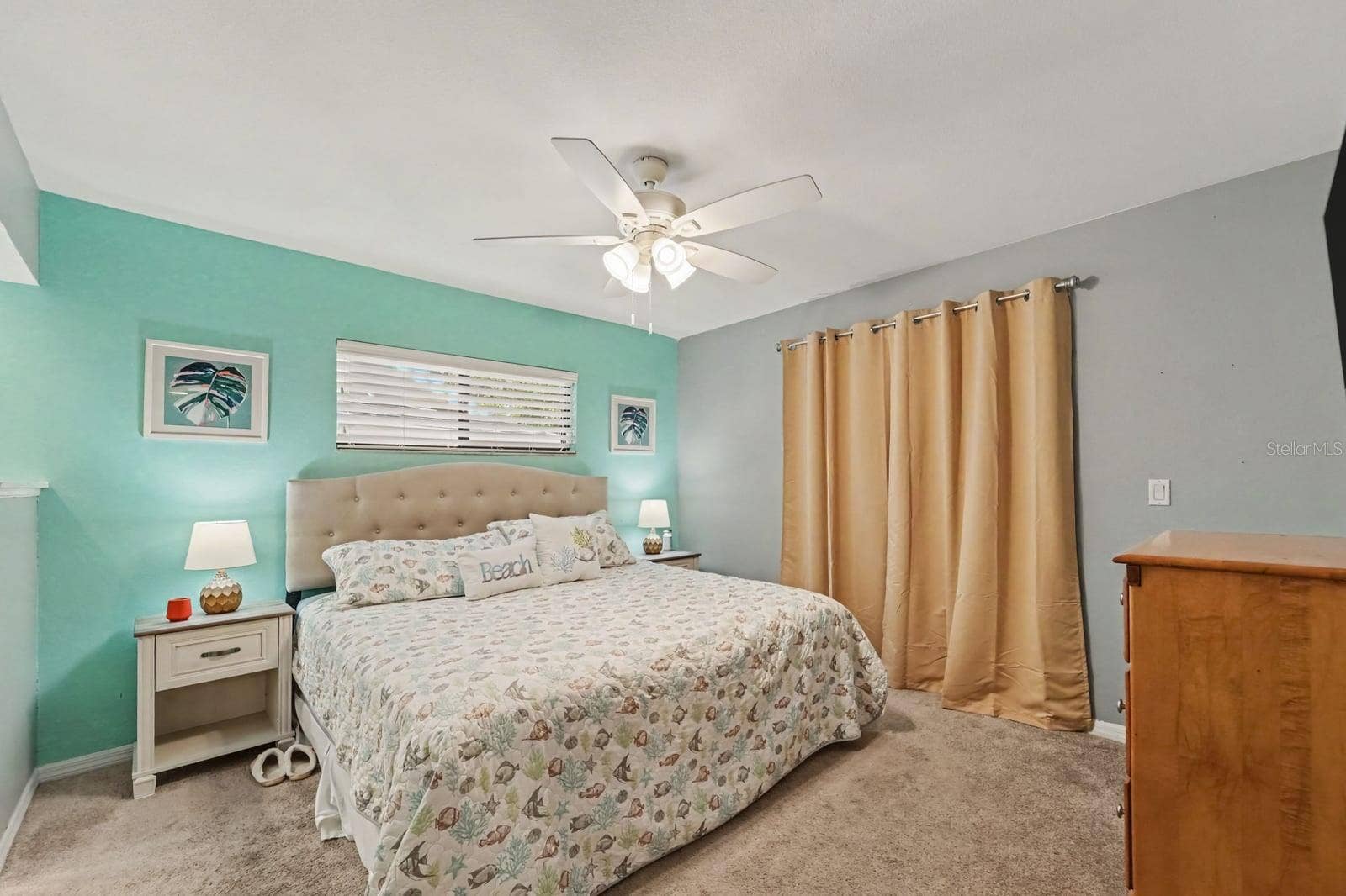143 CROWN POINT CIRCLE, #143, Longwood, FL 32779 Turquoise accent wall and tufted headboard create a bright, coastal-inspired primary bedroom