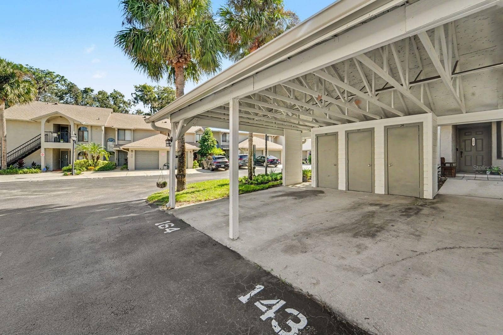 143 CROWN POINT CIRCLE, #143, Longwood, FL 32779 Community Carport Parking With White Posts and Convenient Access