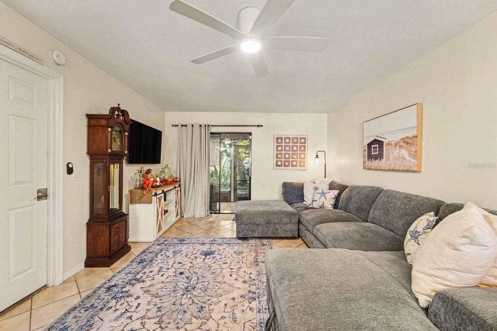 143 CROWN POINT CIRCLE, #143, Longwood, FL 32779 Bright Living Space Features Sectional Sofa and Patio Door with Greenery Views