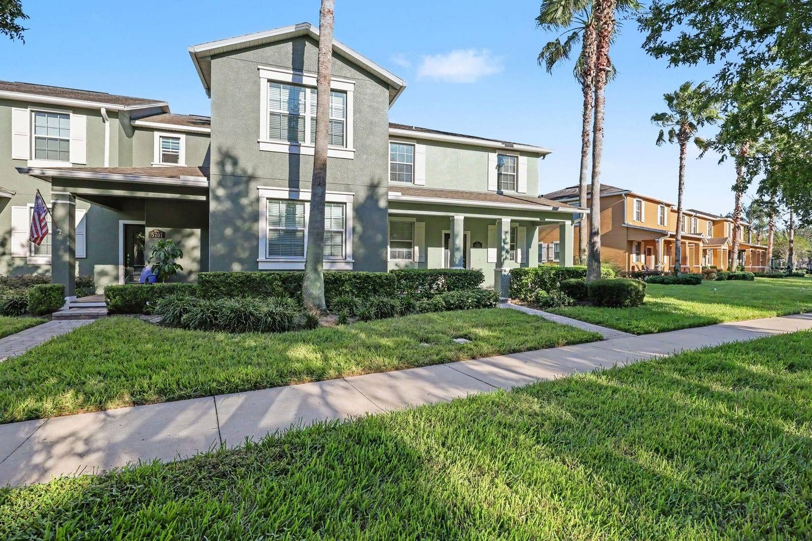 5705 NEW INDEPENDENCE PARKWAY, Winter Garden, FL 34787 Welcoming front porch and covered entry with palm tree-lined setting