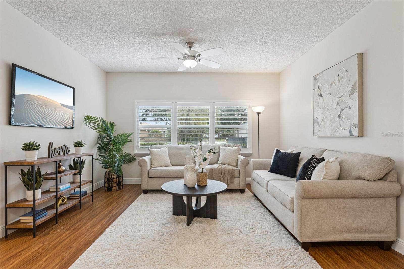 14' x 13' Family Room w/ laminate floor, ceiling fan & Plantation style shutters