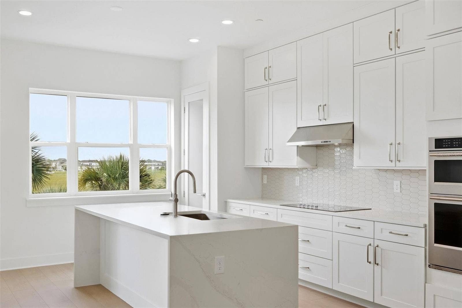 9317 LUMINARY BOULEVARD, Orlando, FL 32827 Waterfall island in kitchen