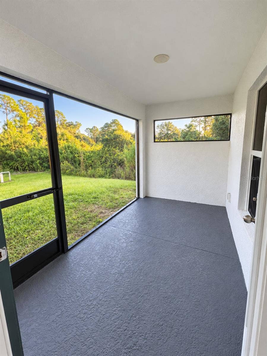 3404 61ST STREET W, Lehigh Acres, FL 33971 Screened lanai digitally enhanced; original patio paint color retained.
