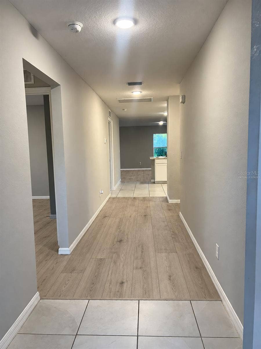 3404 61ST STREET W, Lehigh Acres, FL 33971 Entry hallway virtually staged: planned laminate flooring where shown.