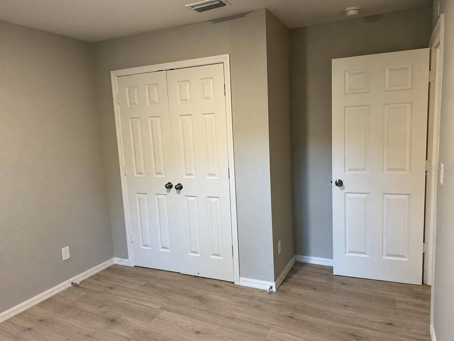 3404 61ST STREET W, Lehigh Acres, FL 33971 Bedroom 1 closet virtually staged: planned laminate flooring.