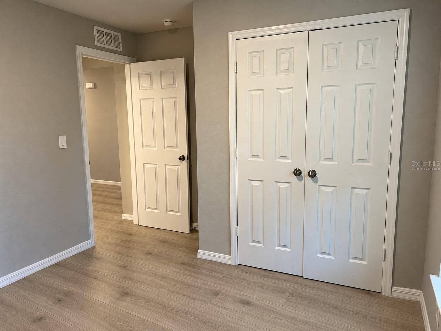 3404 61ST STREET W, Lehigh Acres, FL 33971 Bedroom 2 closet virtually staged: planned laminate flooring.