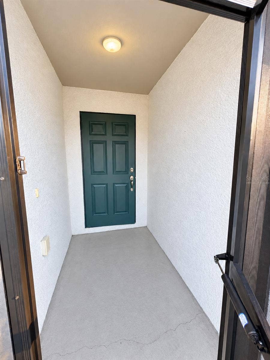 3404 61ST STREET W, Lehigh Acres, FL 33971 Covered entry virtually staged: proposed concrete-gray porch finish.