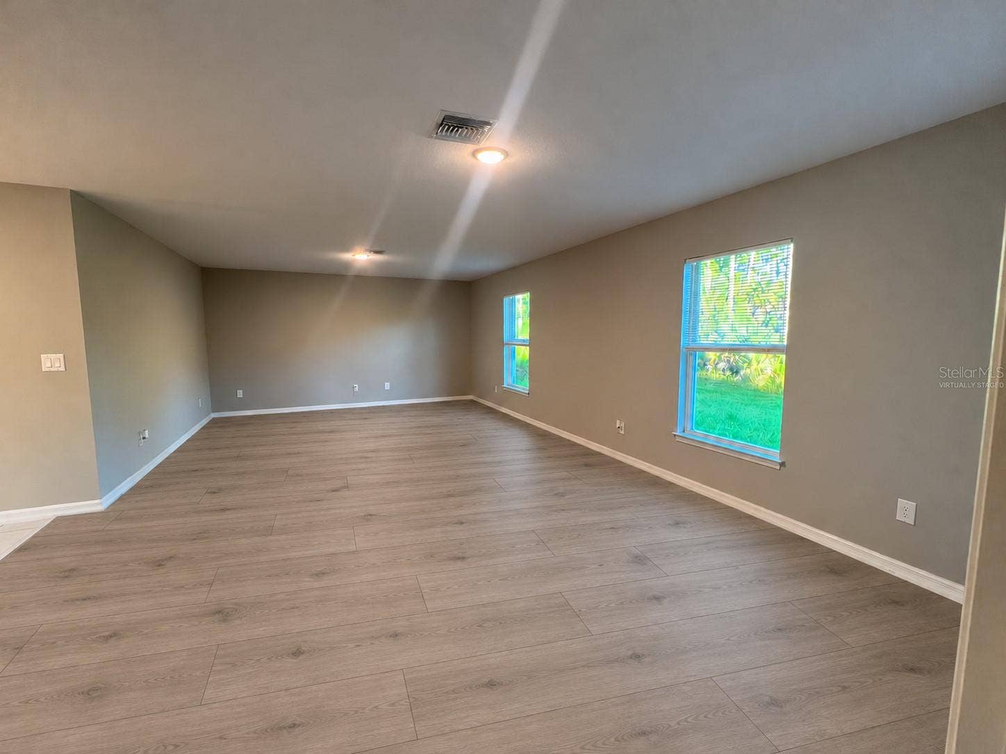 3404 61ST STREET W, Lehigh Acres, FL 33971 Living room virtually staged: planned laminate flooring.