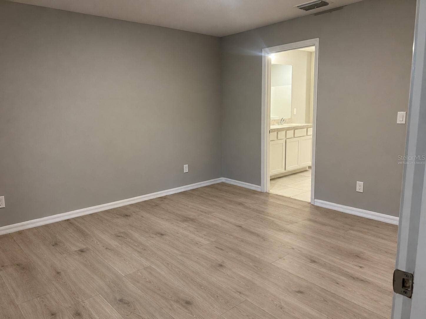 3404 61ST STREET W, Lehigh Acres, FL 33971 Primary bedroom virtually staged: planned laminate flooring.