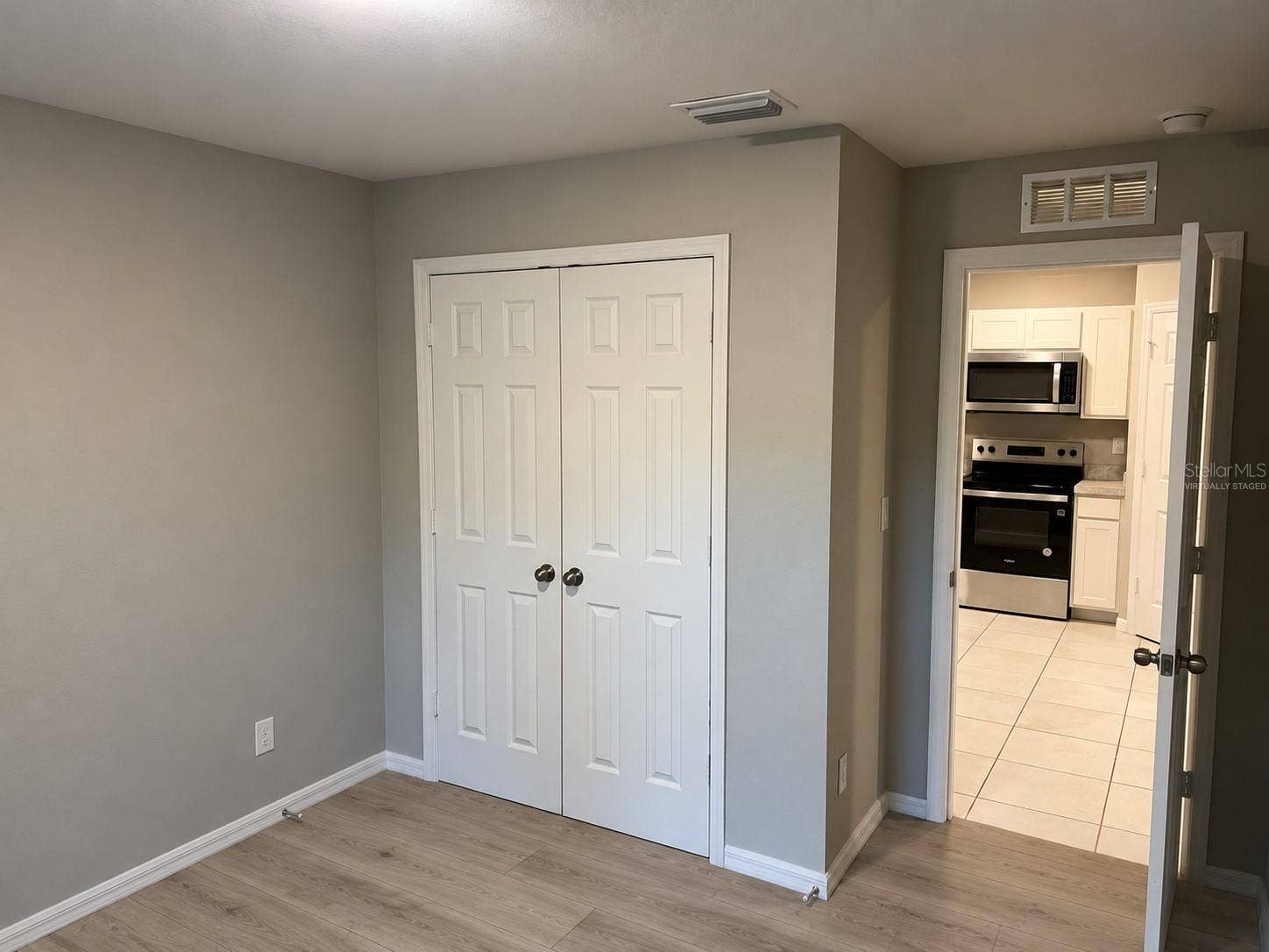 3404 61ST STREET W, Lehigh Acres, FL 33971 Bedroom 3 closet virtually staged: planned laminate flooring.