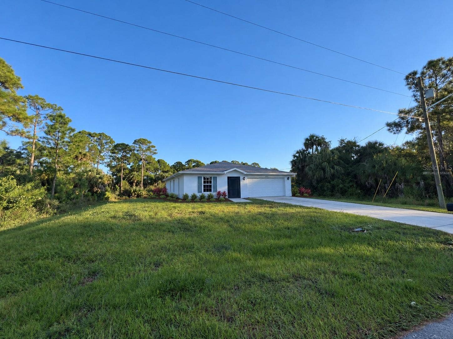 3404 61ST STREET W, Lehigh Acres, FL 33971 Front yard virtually staged: proposed landscaping.
