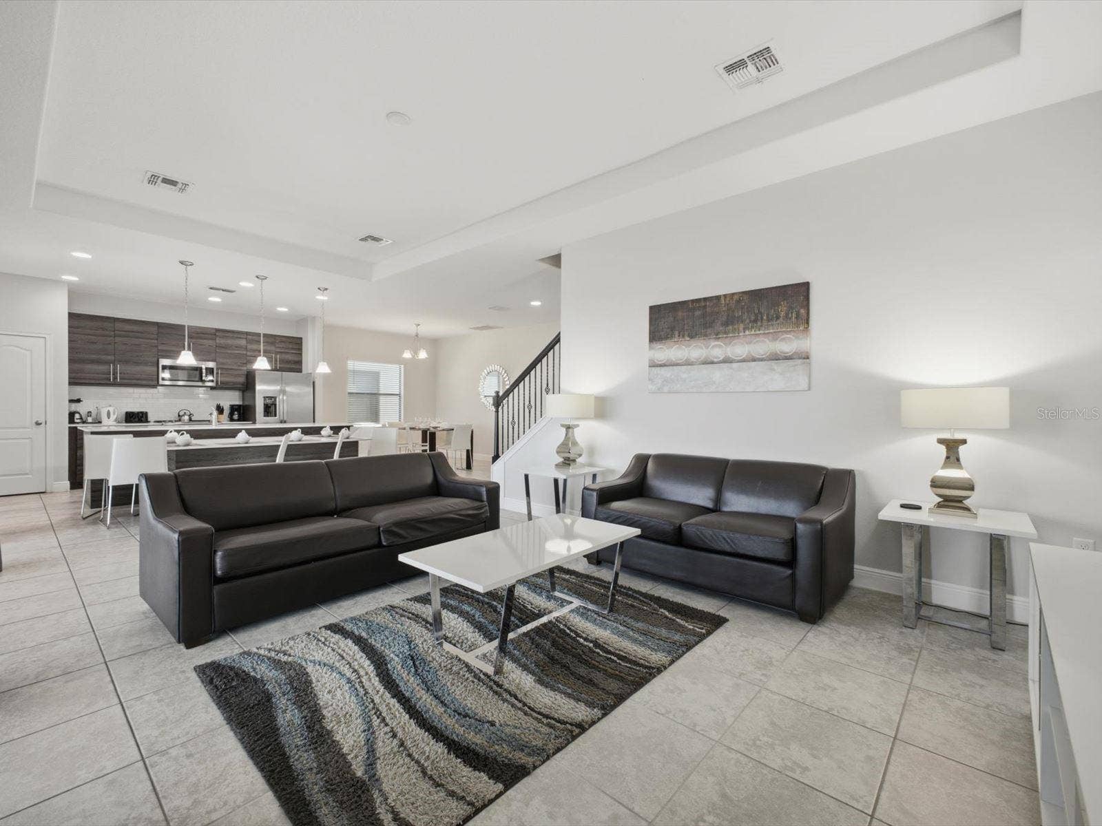 Living room with view into kitchen