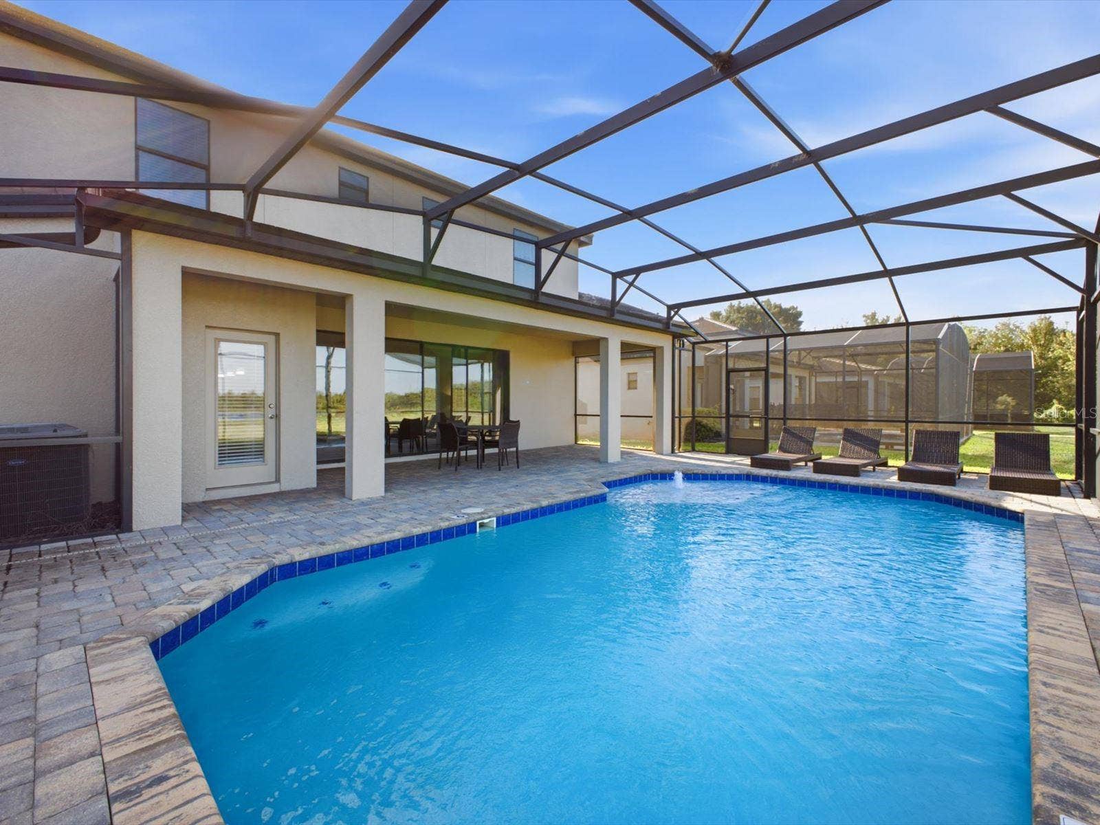 Screened in pool with water view and covered patio