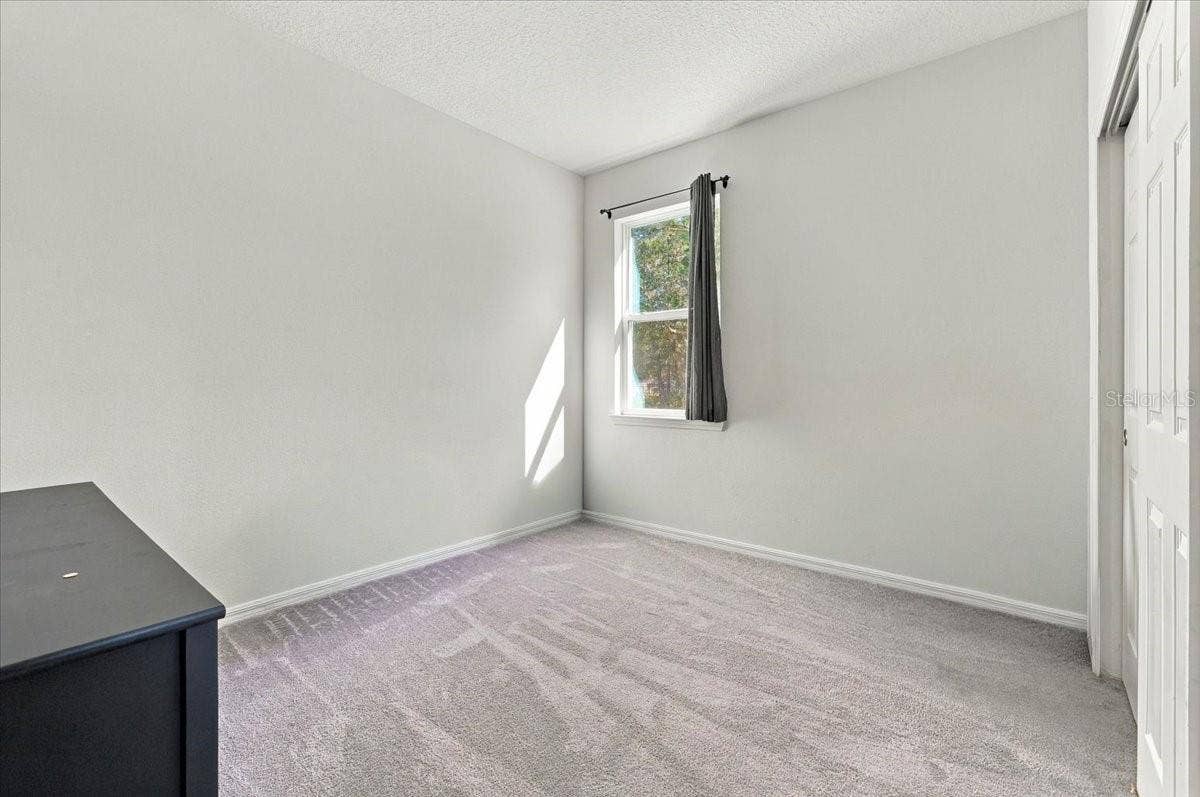 Versatile fourth bedroom, ideal for a guest room, home office, or additional living space.