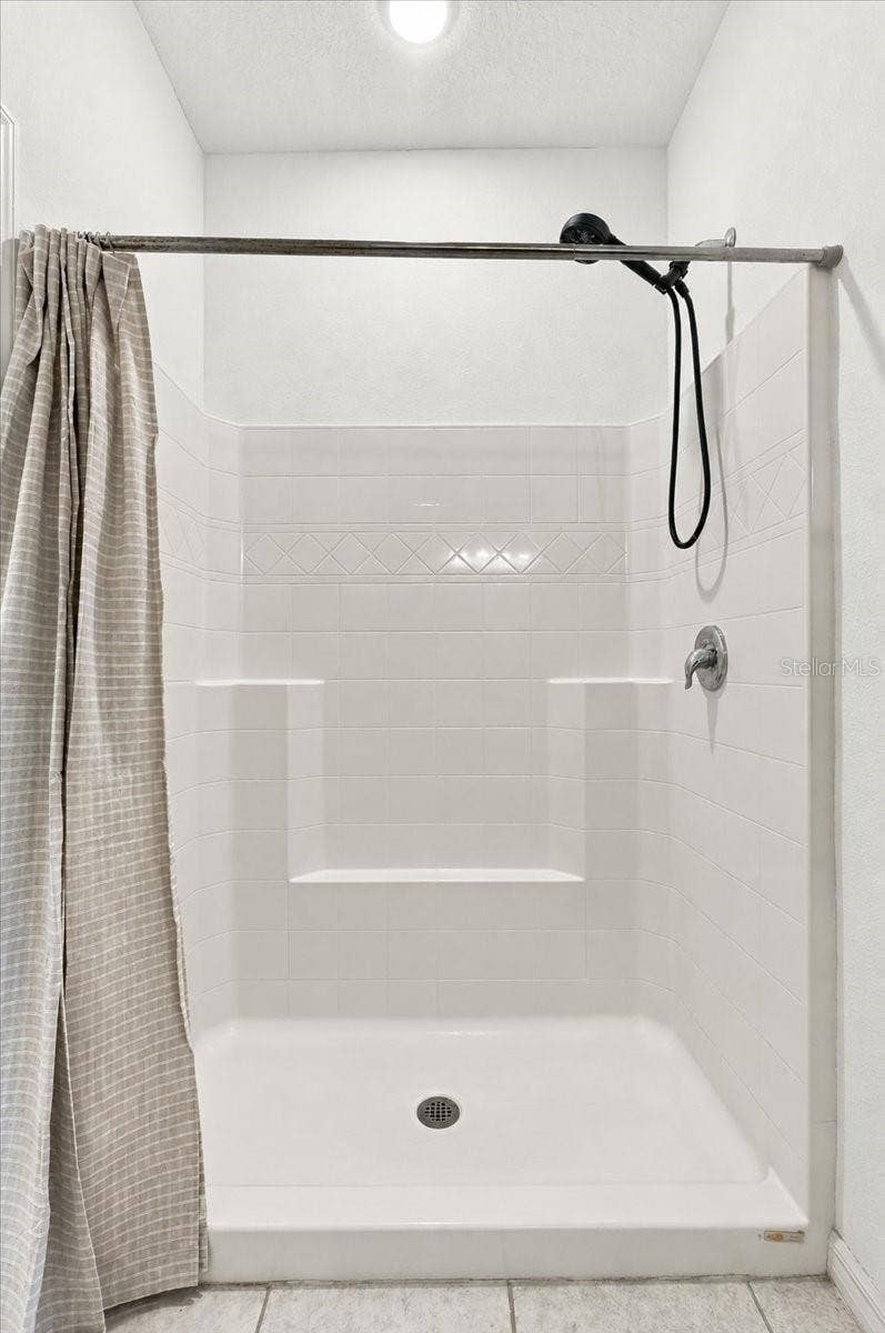 Primary ensuite bathroom featuring a spacious walk-in shower for everyday comfort and convenience.