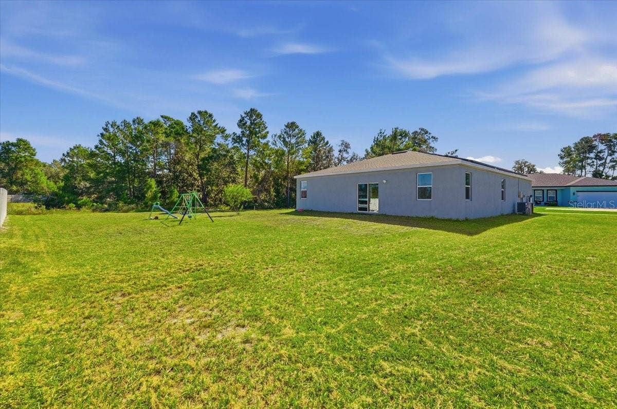 Another view of the generously sized backyard, offering endless possibilities for creating your ideal outdoor retreat.