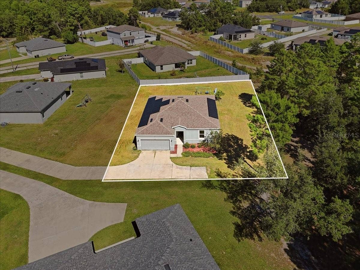 Aerial view showcasing the home's location, lot layout, and surrounding neighborhood.