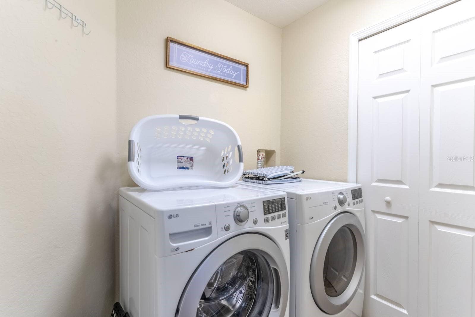 2010 CALABRIA AVENUE, Davenport, FL 33897 Laundry with washer and dryer