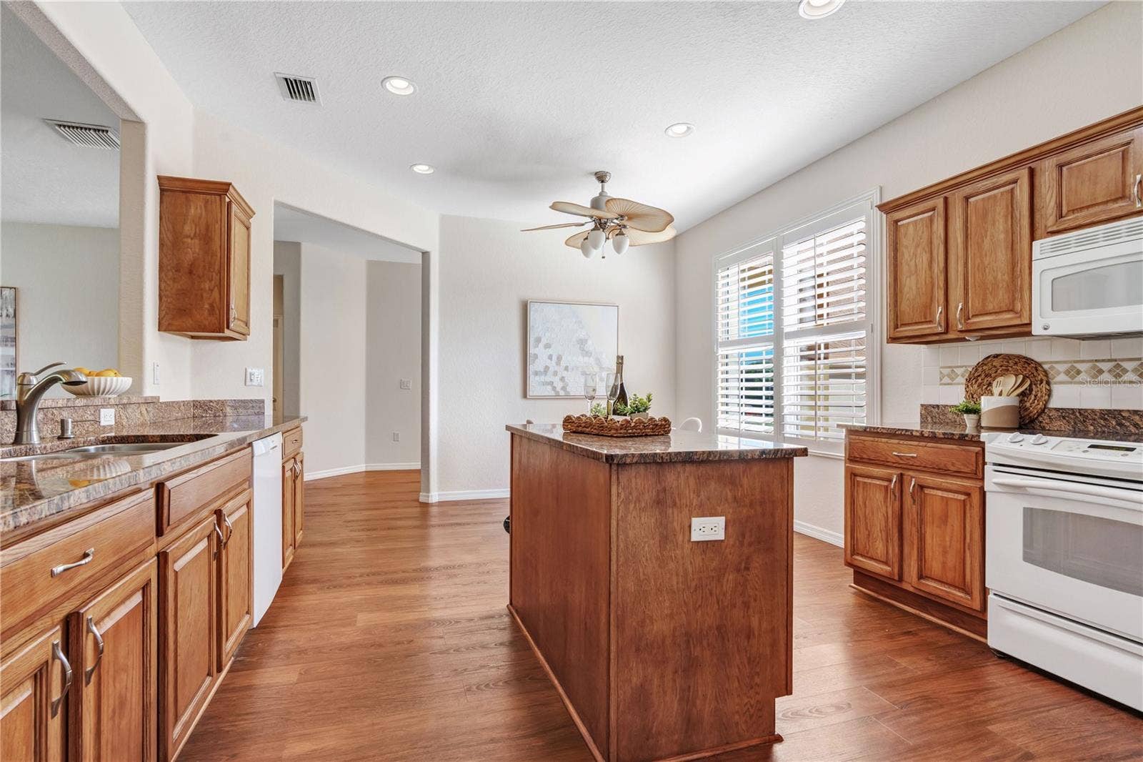 Functional kitchen design with center island, ample cabinetry, and plenty of room for meal preparation.