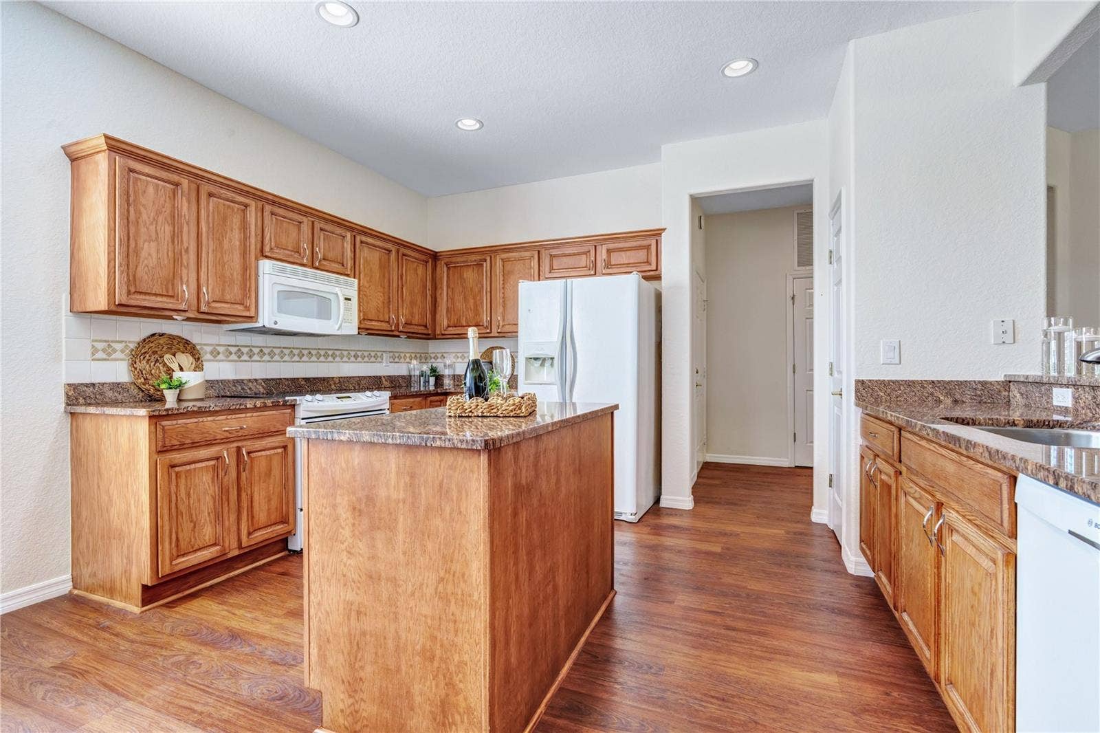 Convenient center island adds valuable preparation space and functionality to this welcoming kitchen.