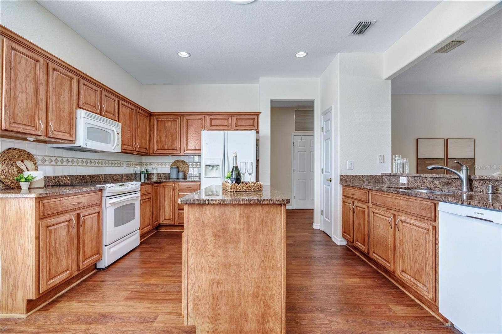 Generous kitchen workspace, wood cabinetry, and an inviting layout designed for comfortable everyday living.