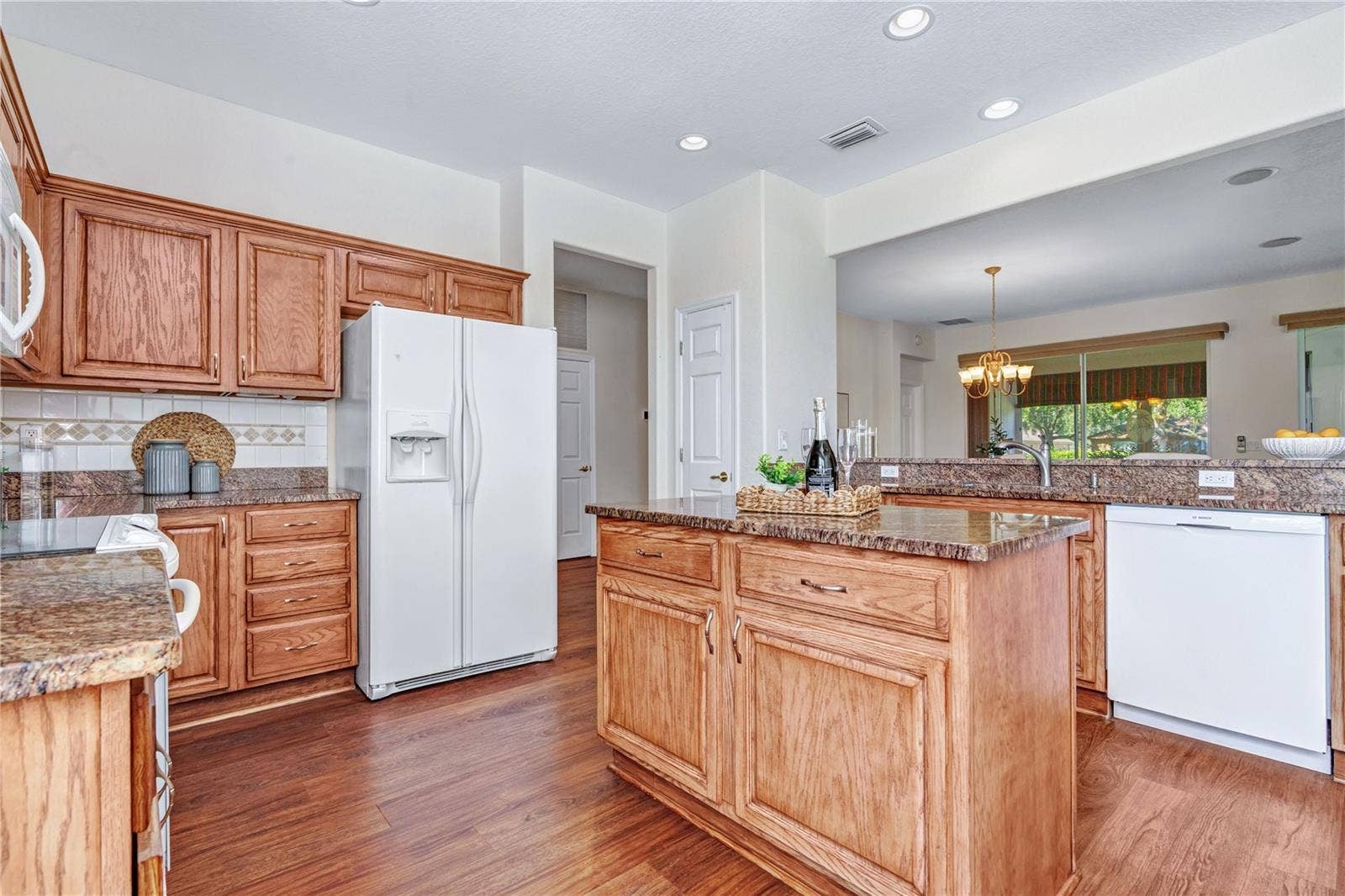 Open kitchen with granite countertops, breakfast bar seating, and easy connection to the main living areas.