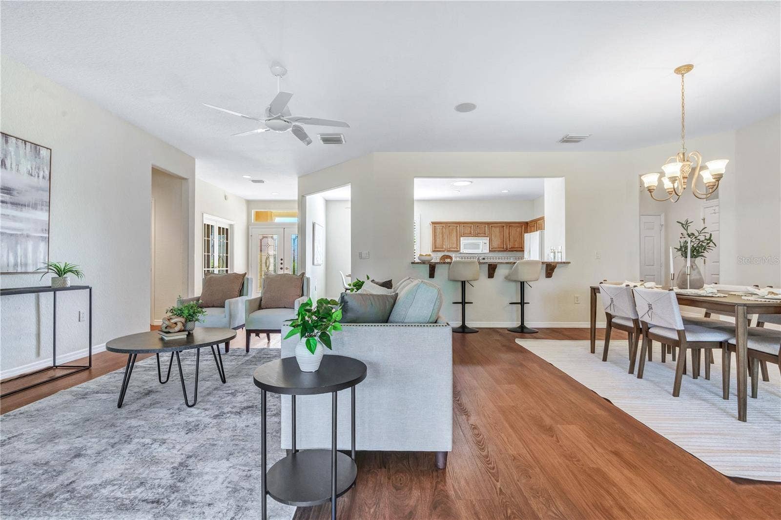 Bright, spacious open floor plan with beautiful flooring and seamless flow between living and dining areas.
