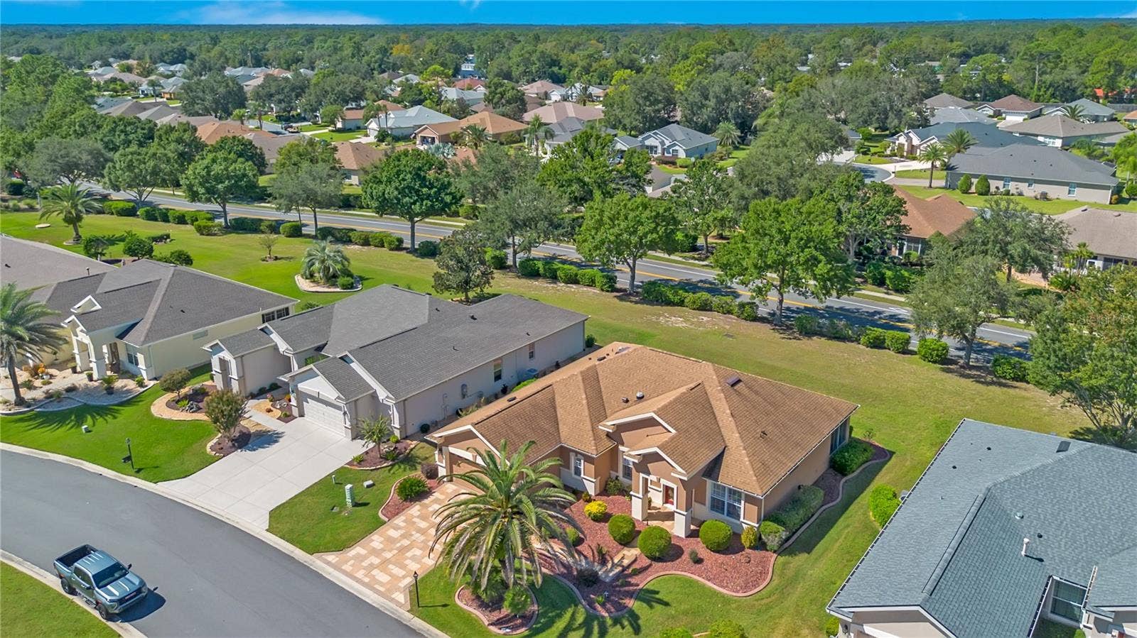 Aerial perspective showcases the home's attractive setting and surrounding residential neighborhood.