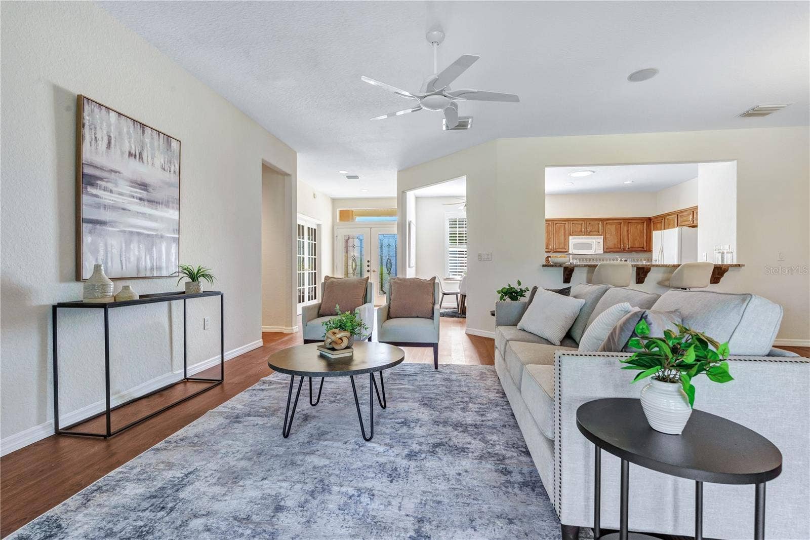 Spacious, light-filled living room with comfortable seating areas and an open, flowing floor plan.