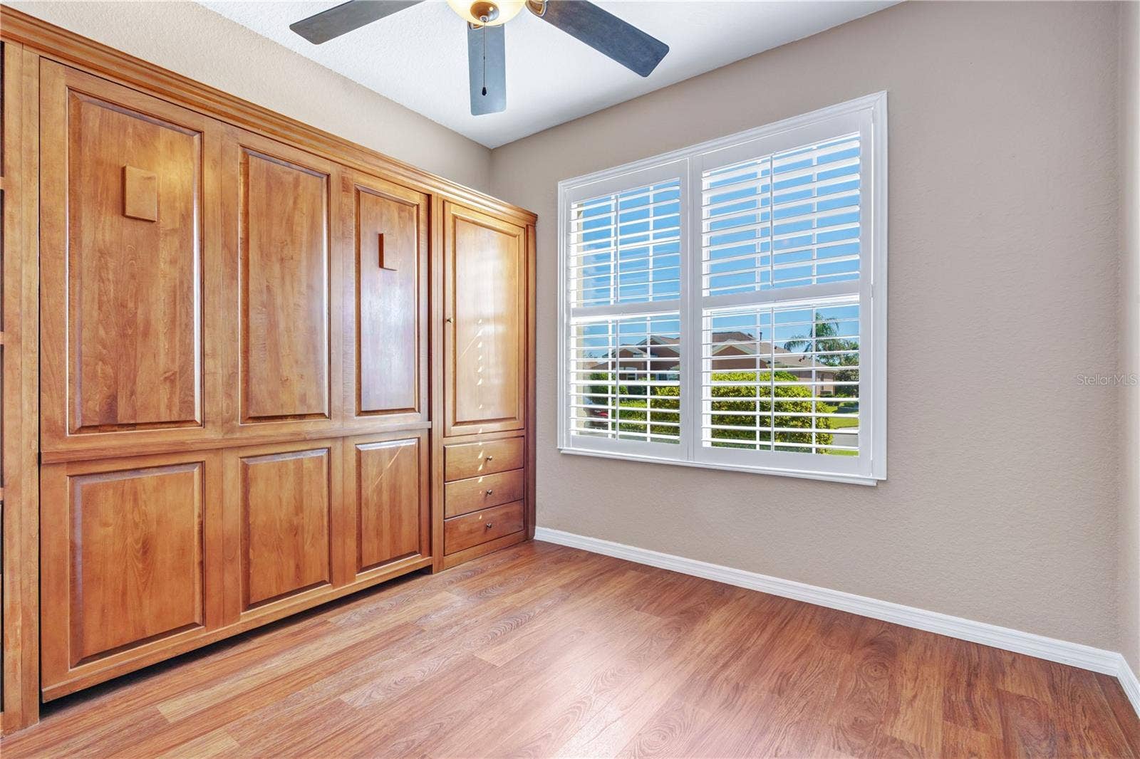 Beautiful cherrywood cabinetry conceals a Murphy bed, maximizing flexibility without sacrificing valuable floor space.