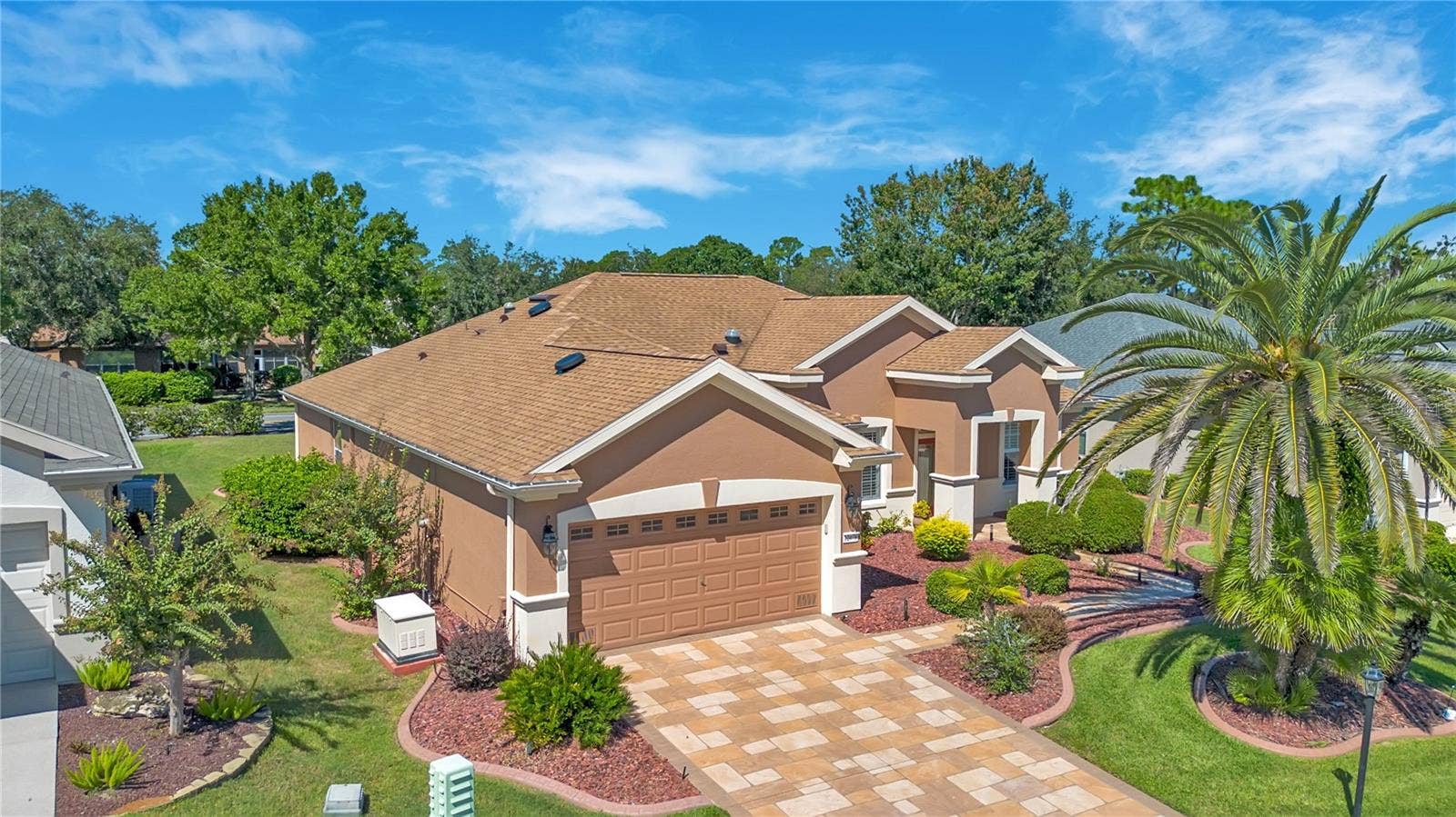Beautifully maintained single-story Granville home with inviting curb appeal and mature tropical landscaping.