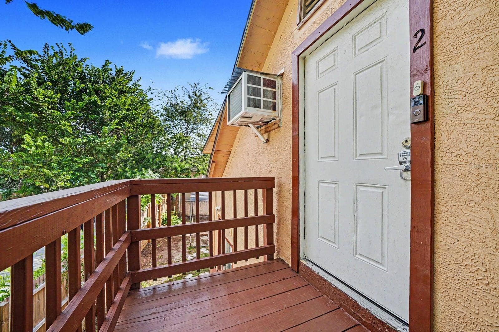 1015 S PENINSULA DRIVE, #1,2, Daytona Beach, FL 32118 Upper Deck with Wood Railing & Access Door to Home