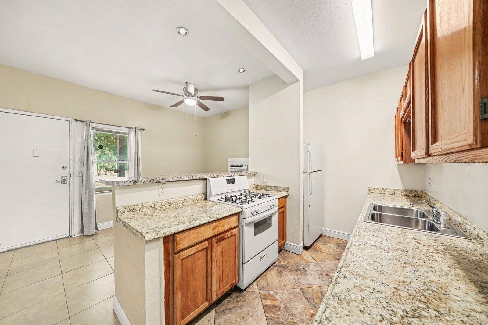 1015 S PENINSULA DRIVE, #1,2, Daytona Beach, FL 32118 Open Kitchen Layout with Island, Gas Range & Access to Backyard