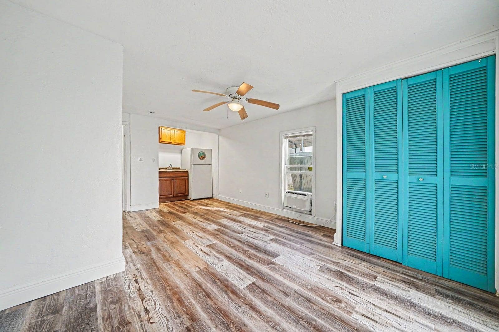 1015 S PENINSULA DRIVE, #1,2, Daytona Beach, FL 32118 Bright Bedroom with Turquoise Closets, Wood Floors & Multiple Windows