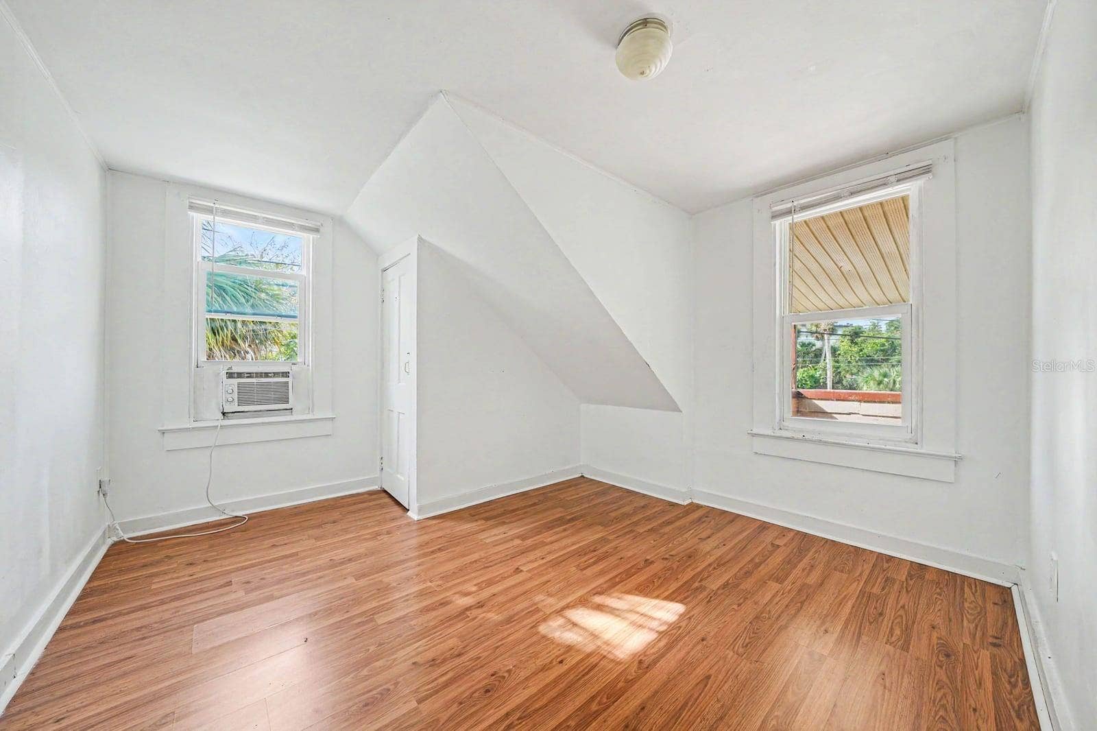 1015 S PENINSULA DRIVE, #1,2, Daytona Beach, FL 32118 Attic Bedroom with Window AC Unit, Two Windows & Wood Flooring
