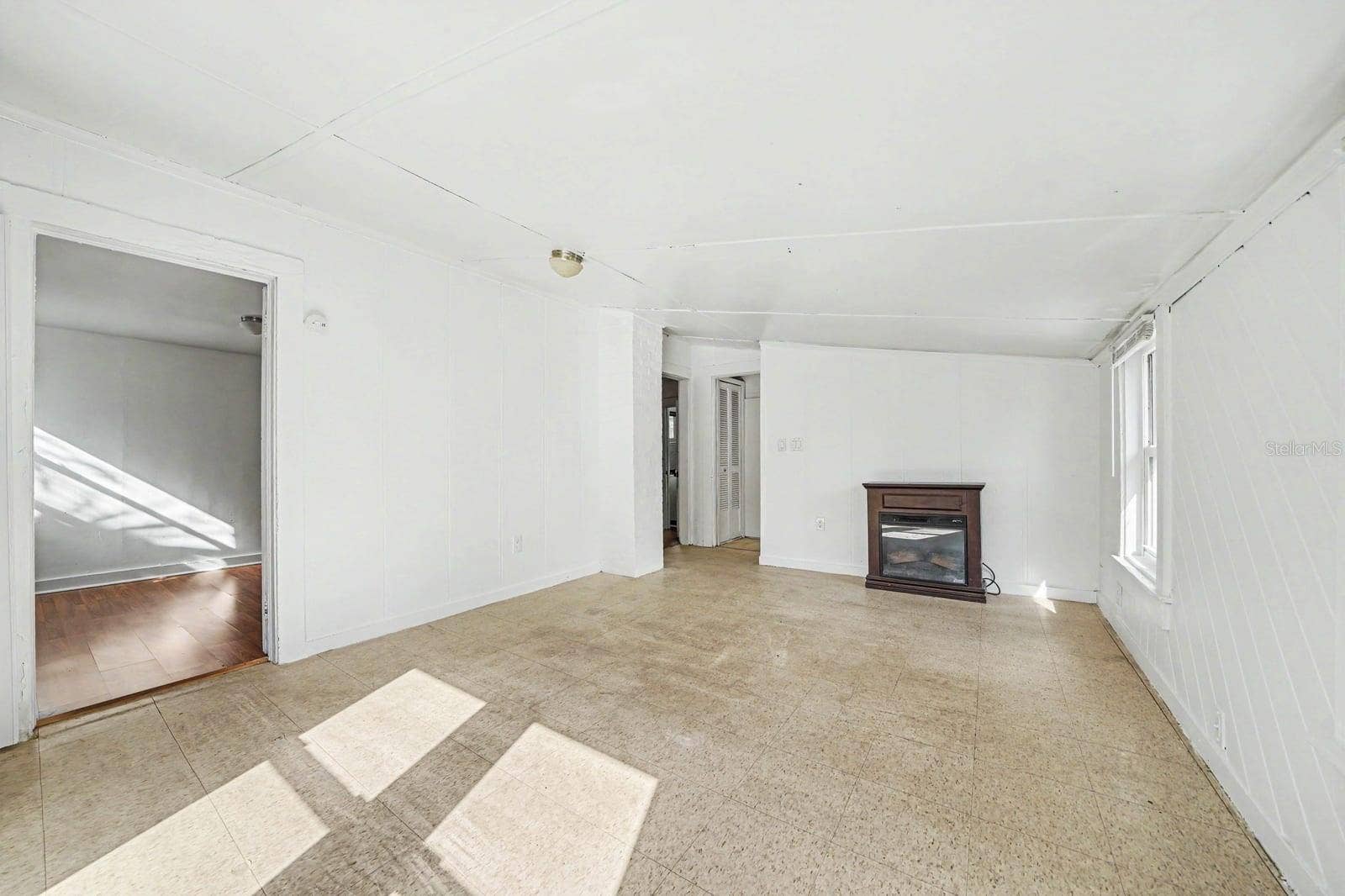 1015 S PENINSULA DRIVE, #1,2, Daytona Beach, FL 32118 Open Living Area with Fireplace, Tile Flooring & Abundant Sunlight
